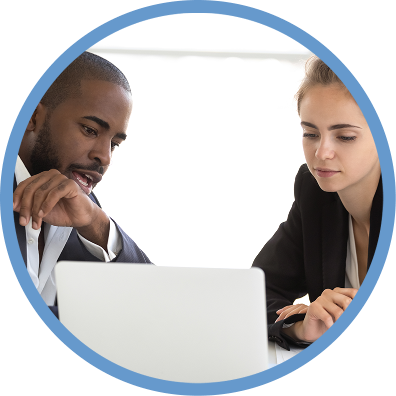 A man and woman looking at a laptop.